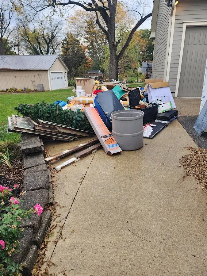 Dumpster being loaded with debris for Estate Cleanout Dumpster Rental in Duncanville